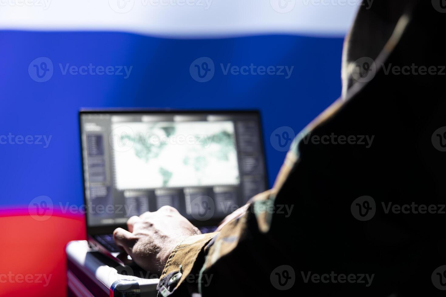 Russian soviet army expert analyzes aerial reconnaissance data to come up with tactics gaining battlefield advantage. Kremlin regime agent in command room controls drones attacking strategic targets photo