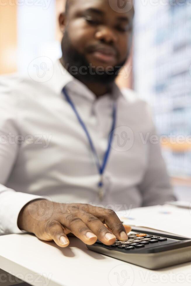 Financial specialist using a calculator to create a projection for retired people income and pension, helping them choose a suitable retirement plan for stability in the future. Close up. photo