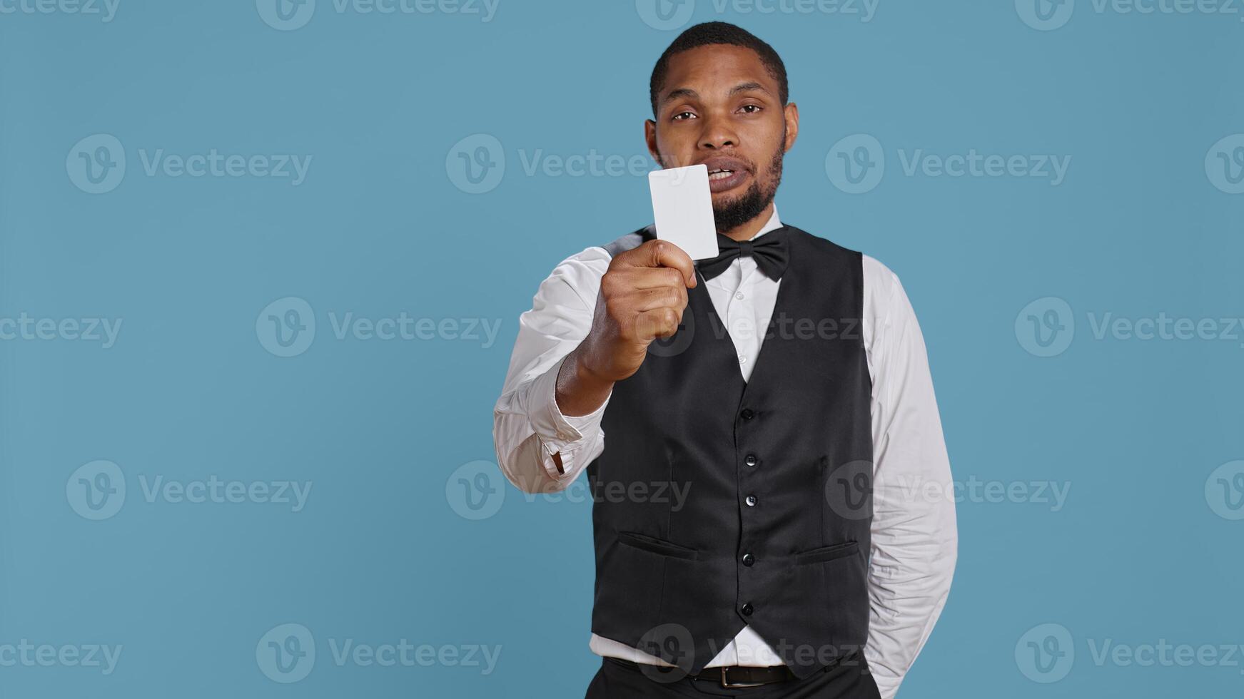 Hotel concierge presenting the room access key card after check in, providing luxury lodging and amenities at five star holiday resort. Reception personnel gives assistance to guests. Camera B. photo