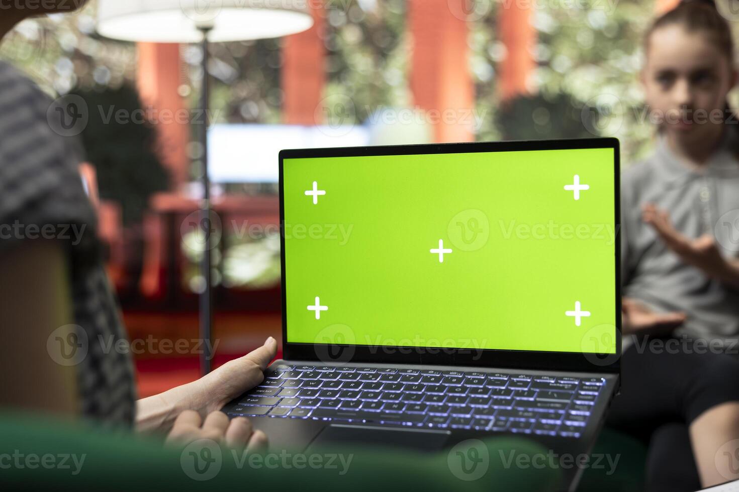 Therapist uses green screen display in a counseling session with an adolescent dealing with low confidence. Psychotherapist supports her in building resilience and self esteem. photo