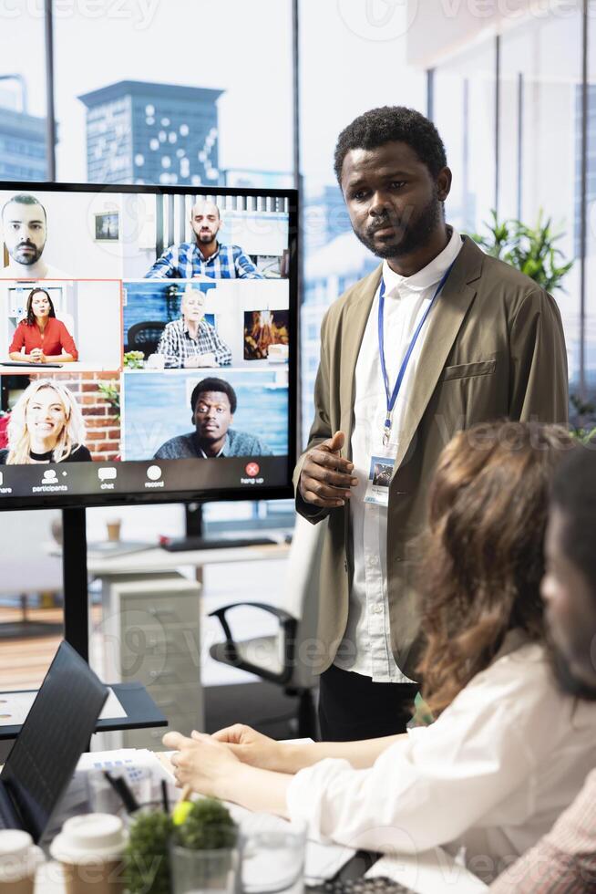 Diverse team of workers reviewing project updates together with shareholders on call online meeting, ensuring easy remote collaboration for global business expansion plans. Teamwork. photo