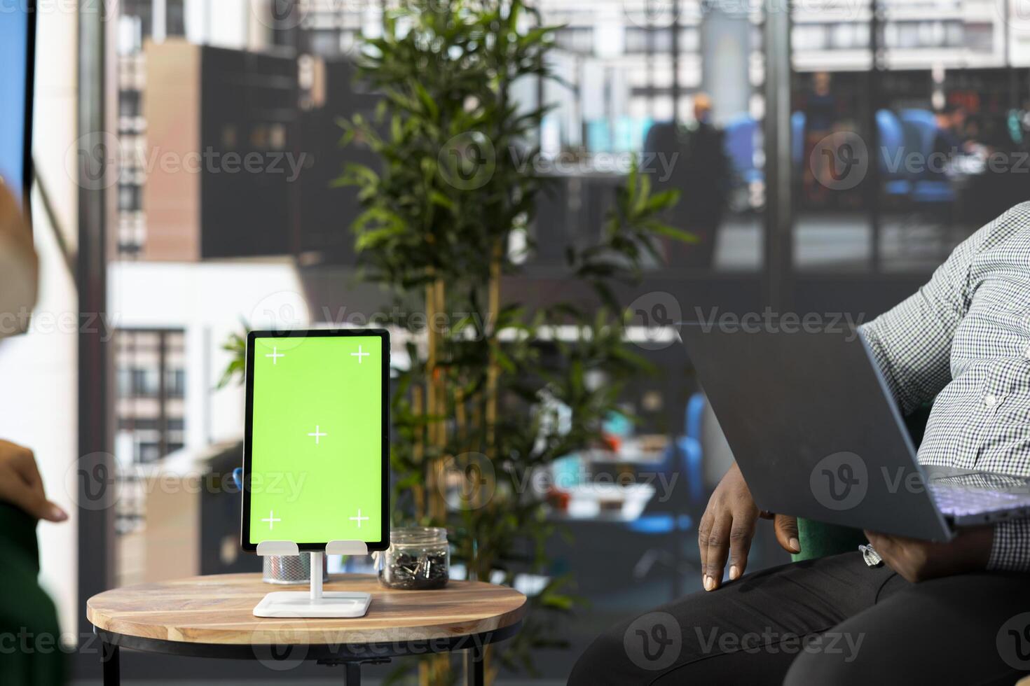 Isolated screen tablet next to manager working on laptop in office, coordinating company administrative operation. Supervisor reviewing business procedures on chroma key device photo