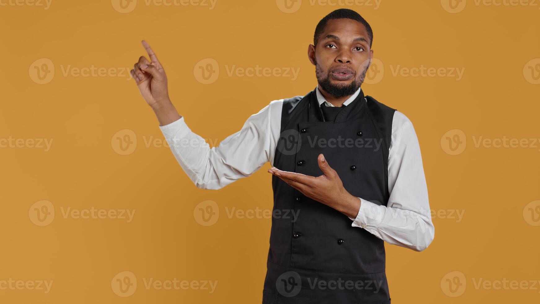 Friendly restaurant staff indicating direction to left or right sides, doing an advertisement for great customer service. Waiter showing professionalism in catering environment. Camera B. photo