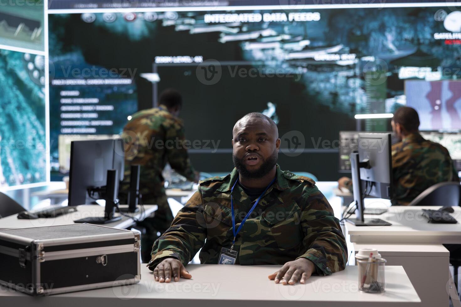 Army personnel in a high tech command center attends a videocall meeting and communicating crucial information from surveillance systems and cctv. Support national security operations. photo