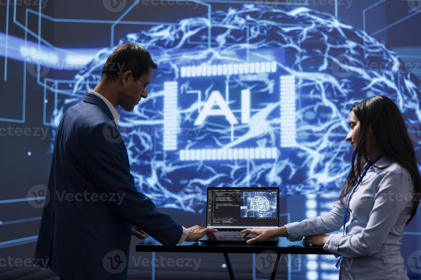 Engineer and coworker use AI cognitive computing to extract information from complex data on laptop. IT staff members using artificial intelligence on notebook to accelerate complex calculations photo