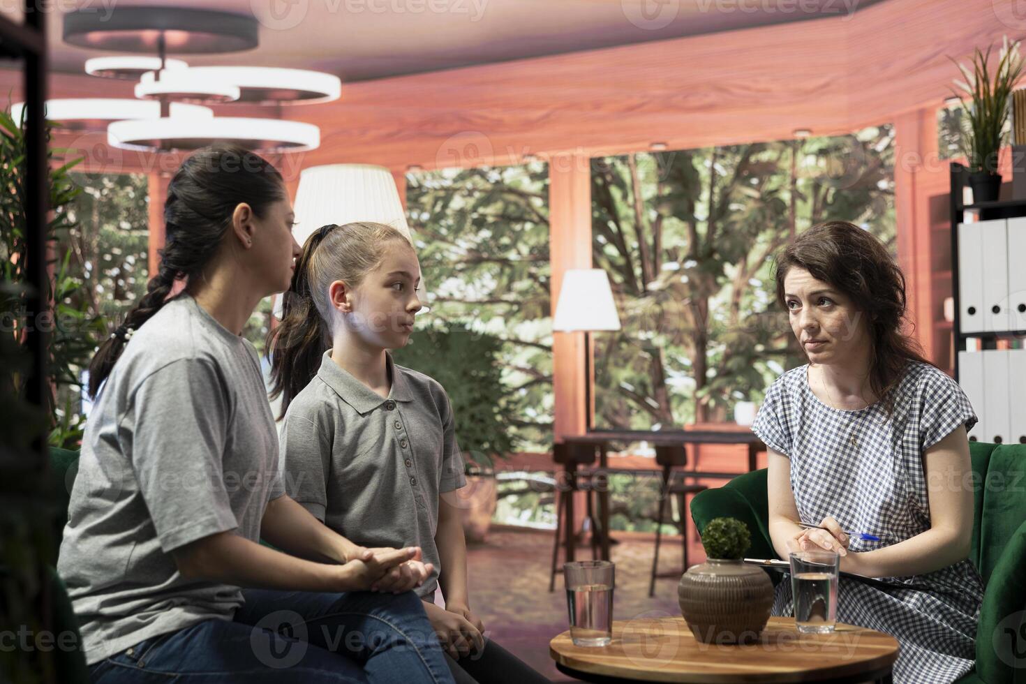Mother and her teenager daughter consult with a therapist for advice on mental wellbeing. The session covers family dynamics, personal issues and resilience through behavioral therapy. photo