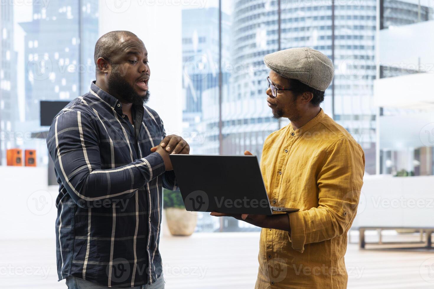 Entrepreneur meeting with a real estate broker on an office tour, guiding the client around the high class workspace and presenting the architectural plans and blueprints. Business investment. photo