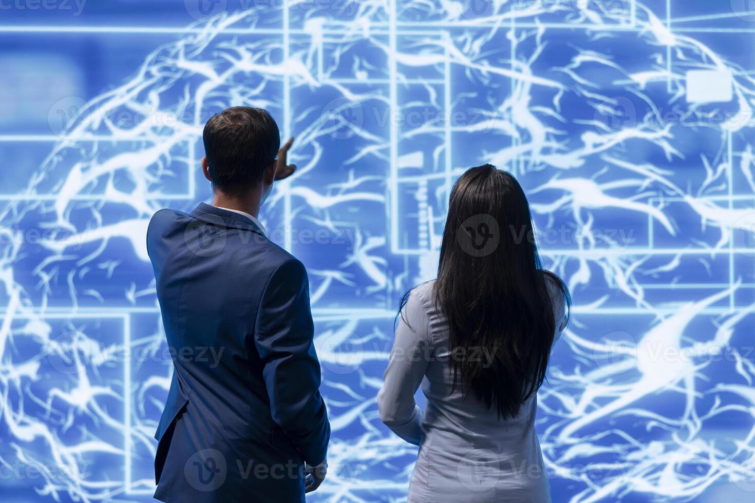 Coworkers doing brainstorming, using AR visualization to fix artificial intelligence neural networks. High tech workspace colleagues using AI system aiding in processing and transmitting information photo