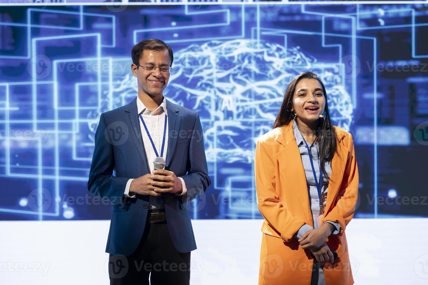 Happy host and expert guest talking at AI summit bringing together tech company employees, exploring latest innovations and discoveries in artificial intelligence industry photo