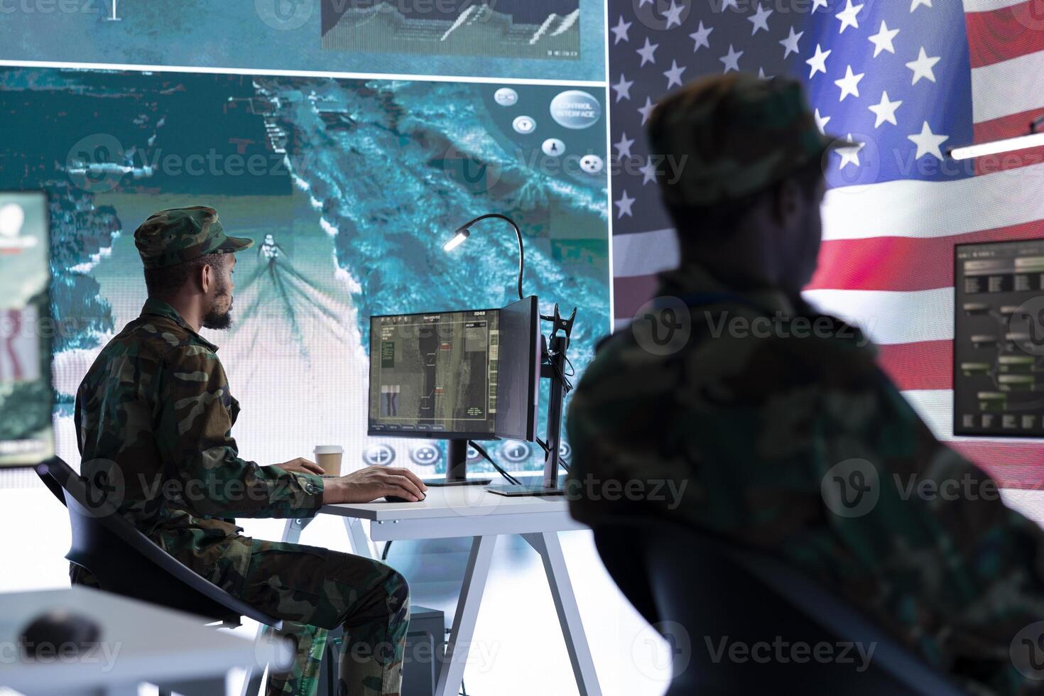 US army official working on ensuring servers protection and state secrets, protecting important hybrid warfare data in high tech agency office. Military soldier supervises hacking activity. photo