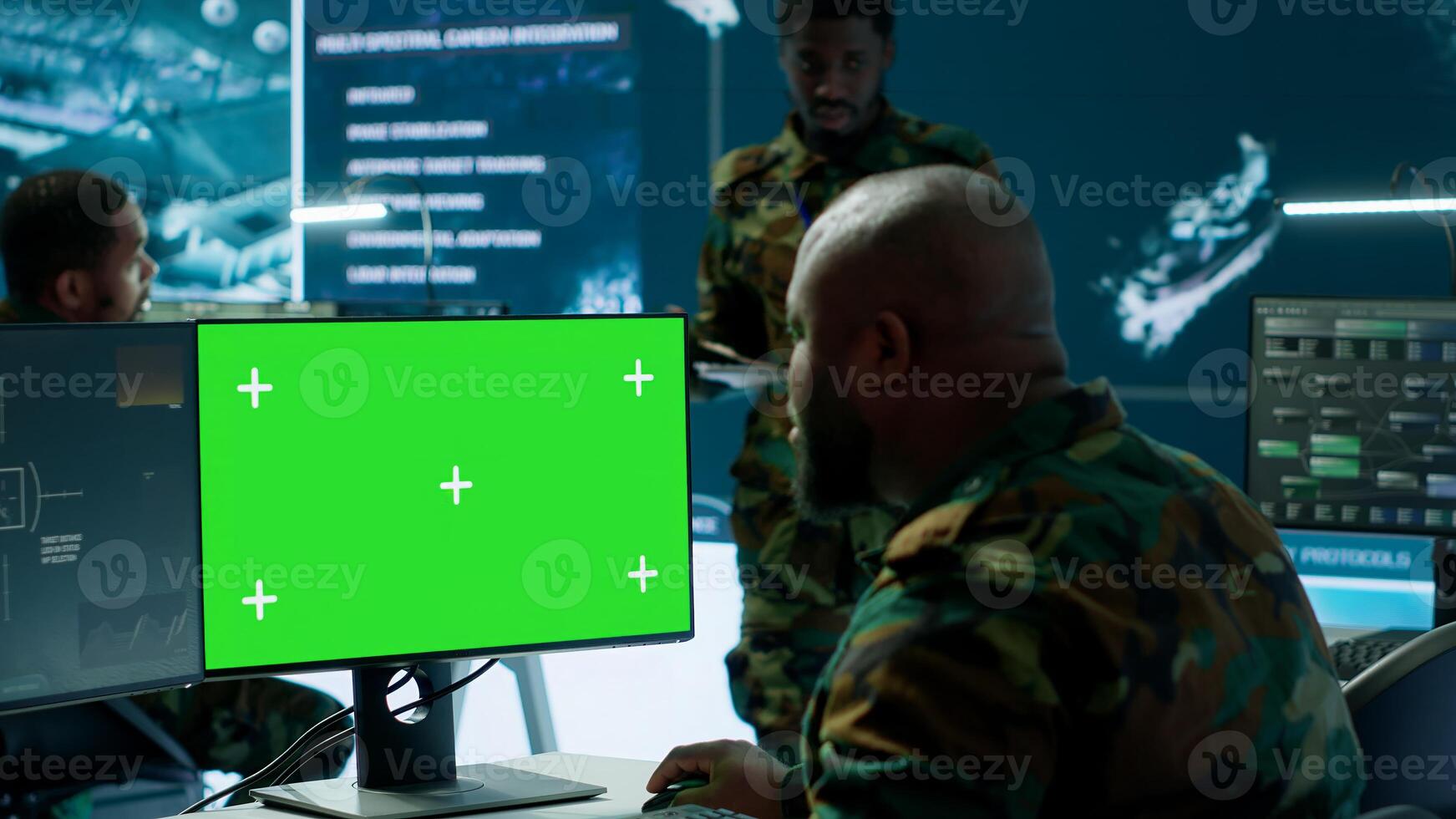 Soldier analyzing real time data next to green screen in high tech military office, processing intelligence for field operations and coordinating strategic missions to ensure national interests. Camera A. photo