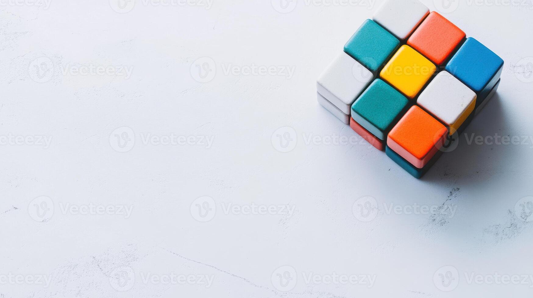 Colorful Rubik's Cube rests on a white surface, inviting puzzle enthusiasts to solve its complexities in a relaxing environment photo