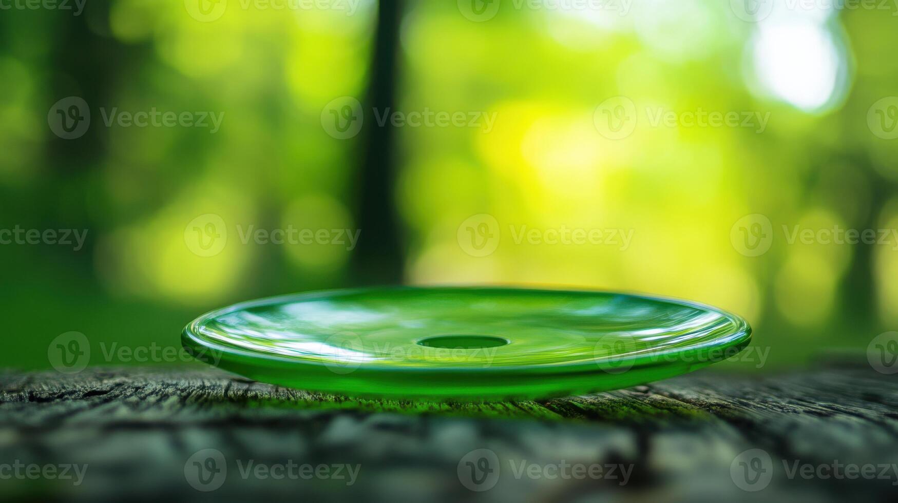 A green glass object sitting on top of a wooden table photo