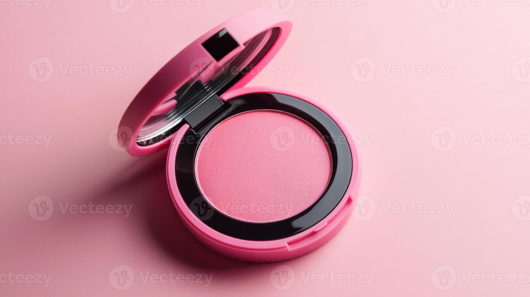 Bright pink blush compact open on a pastel pink background showcasing vibrant color and sleek design photo