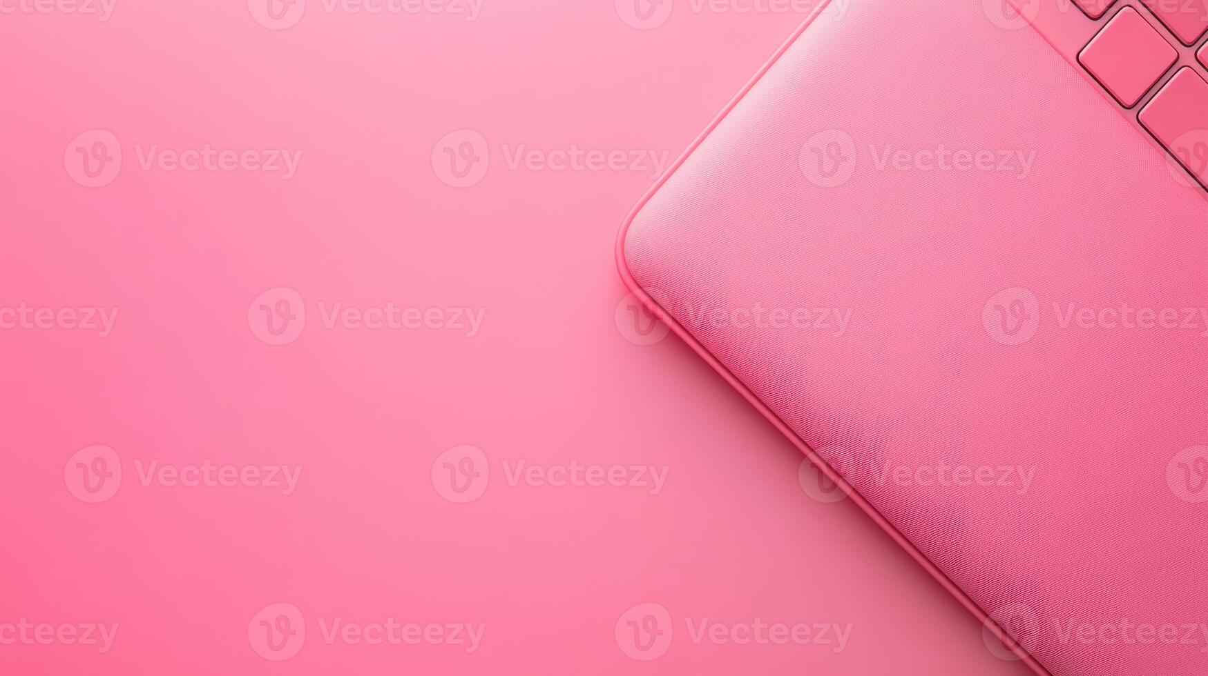 Top view of a pink laptop on a pink background photo