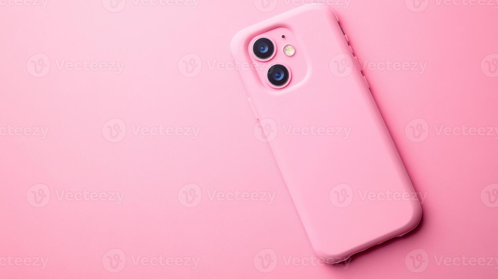 Pink smartphone rests on a pastel surface, showcasing modern design and aesthetic appeal in a minimalistic setting photo