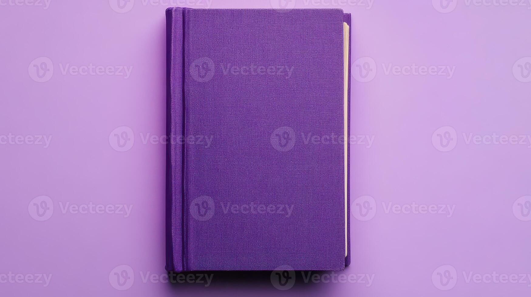 Purple hardcover book resting on a flat surface with a smooth texture and vibrant color photo