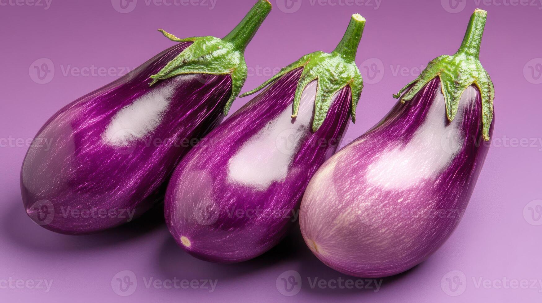 Fresh purple eggplants arranged on a solid background showcasing their vibrant color and appealing texture photo