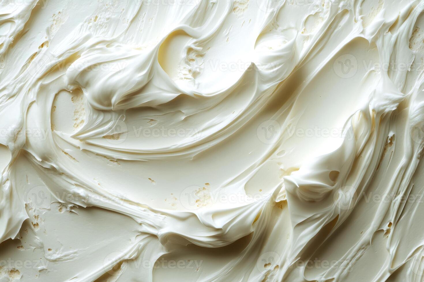 Creamy white frosting swirls creating a delicious background texture photo