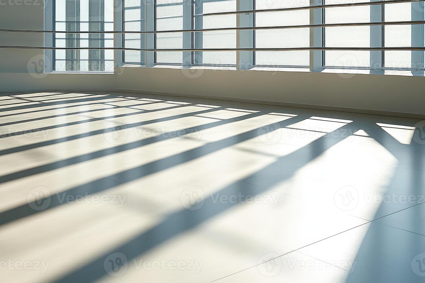 Sunlight creating shadows on empty office floor by window photo