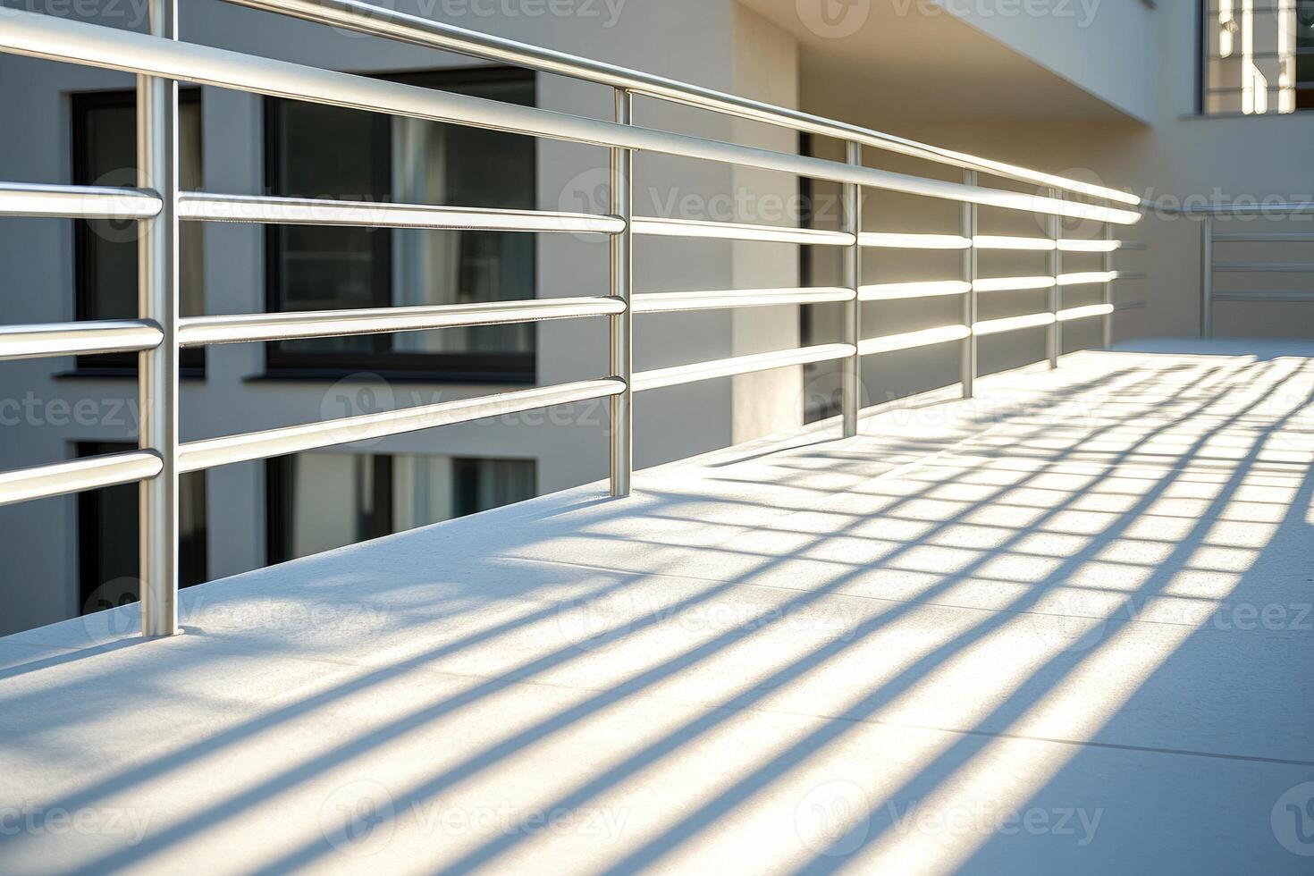 Chrome steel balcony railing casting shadow on building terrace photo