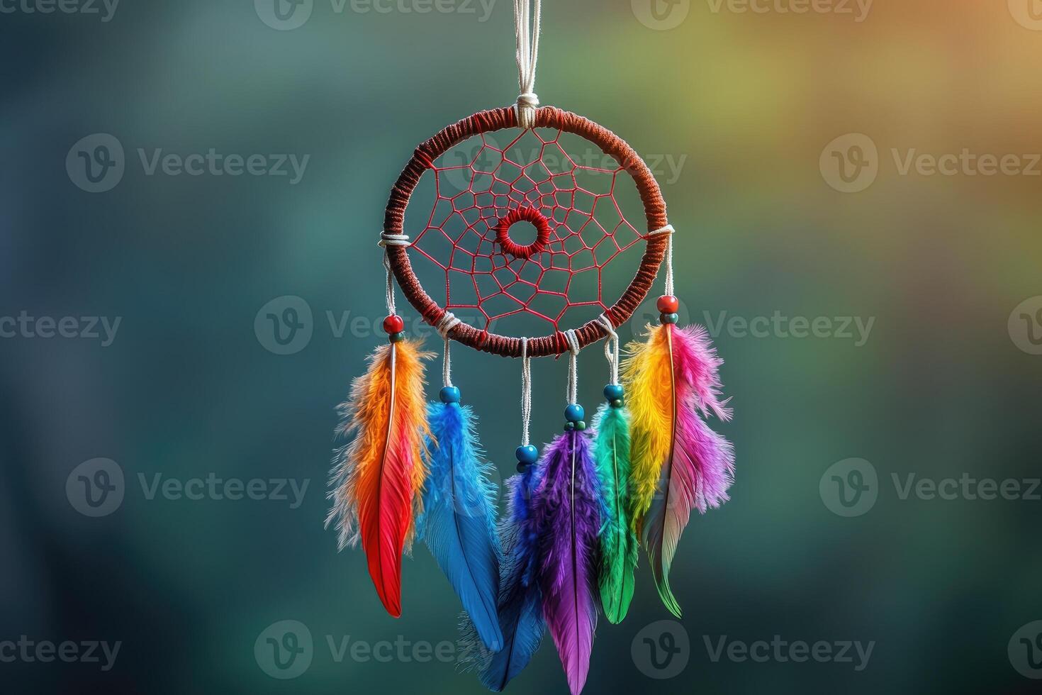 Colorful dream catcher hanging with bright rainbow feathers and blurred background photo