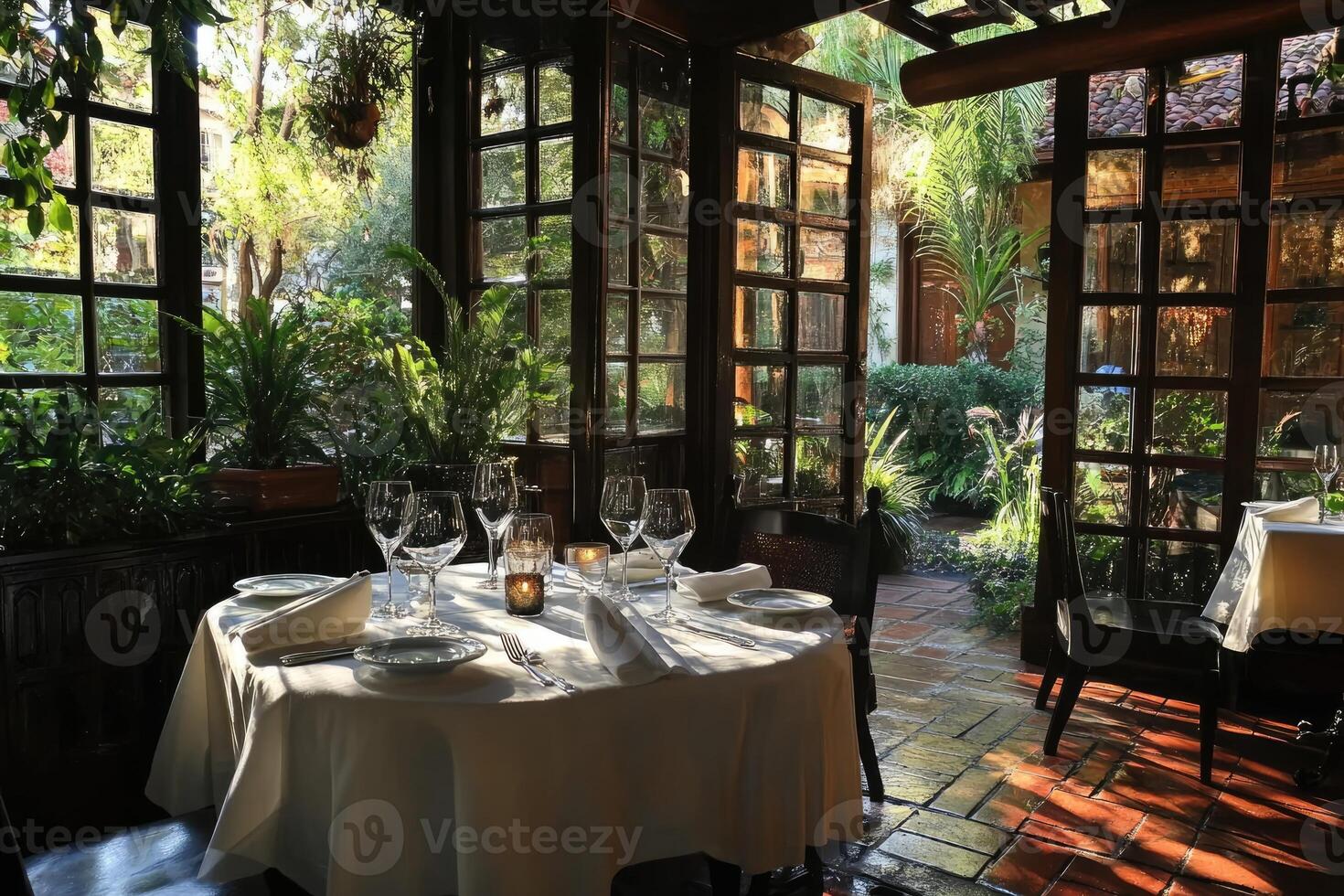 Elegant restaurant table setting overlooking lush garden through open french doors photo