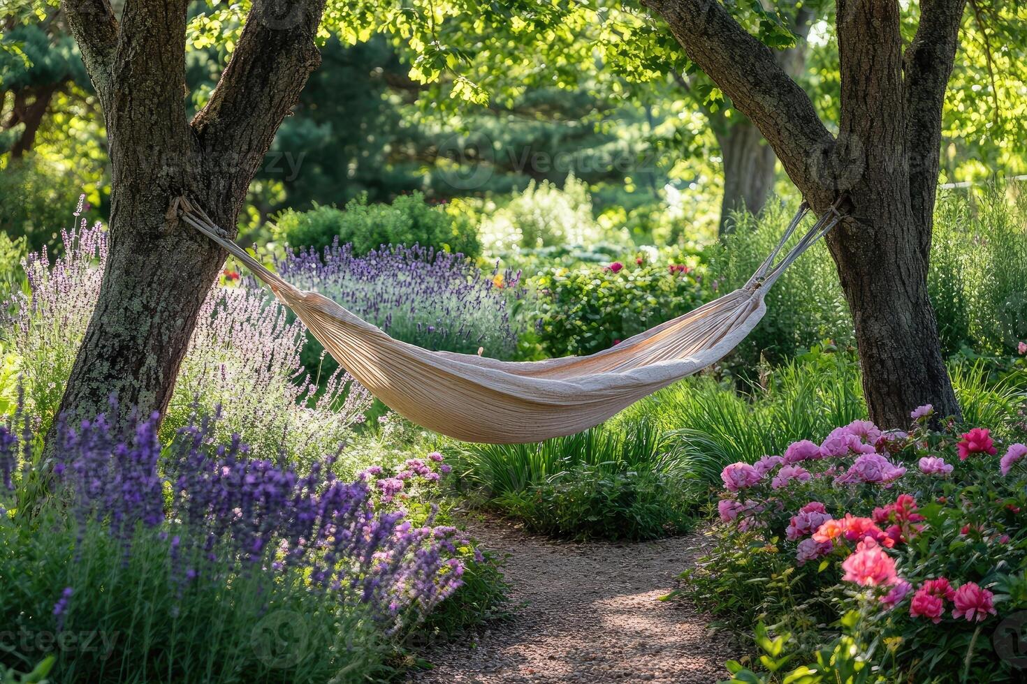 Hammock hanging between trees in peaceful blooming garden photo