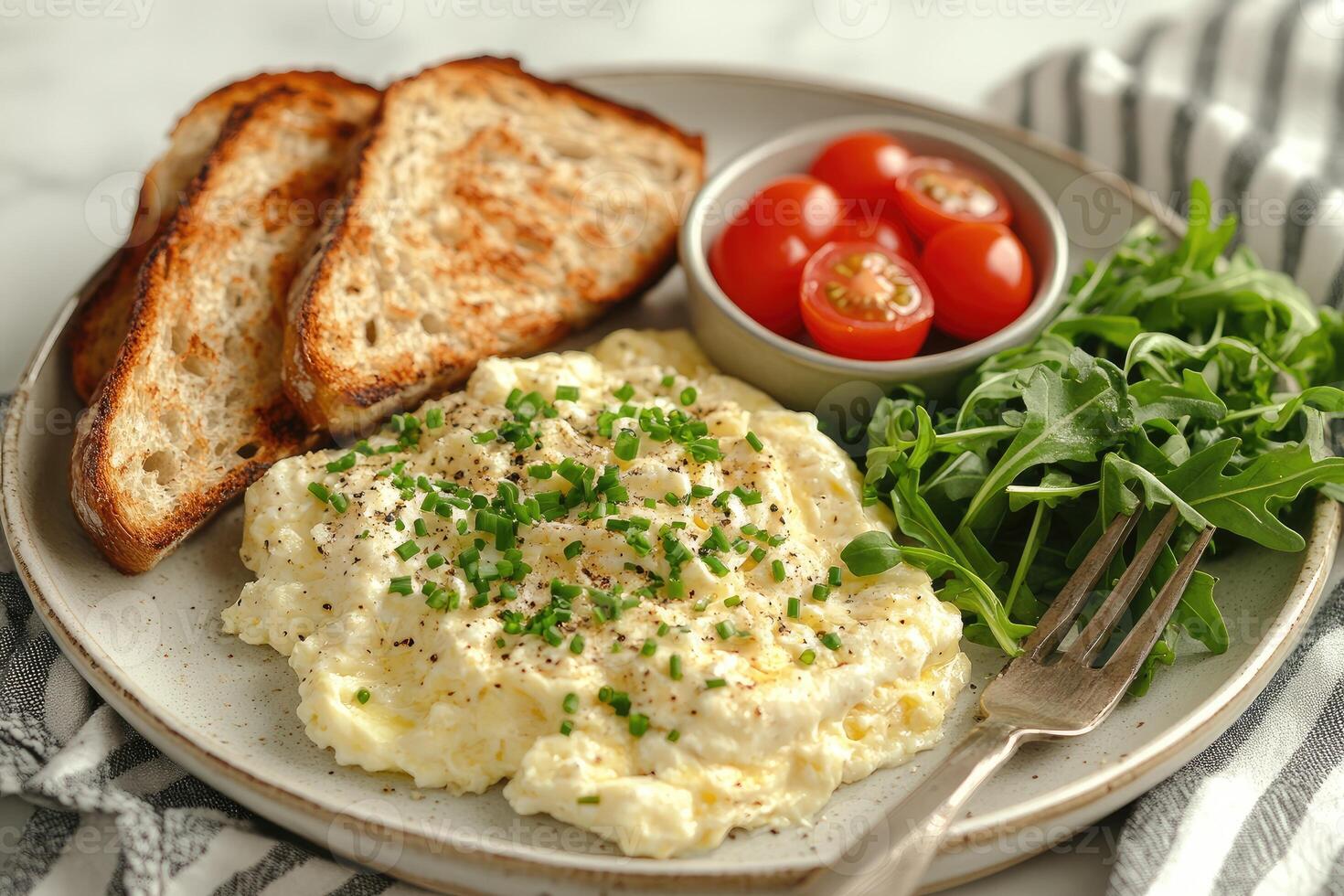 Scrambled eggs with cherry tomatoes, arugula and bread for healthy breakfast. photo