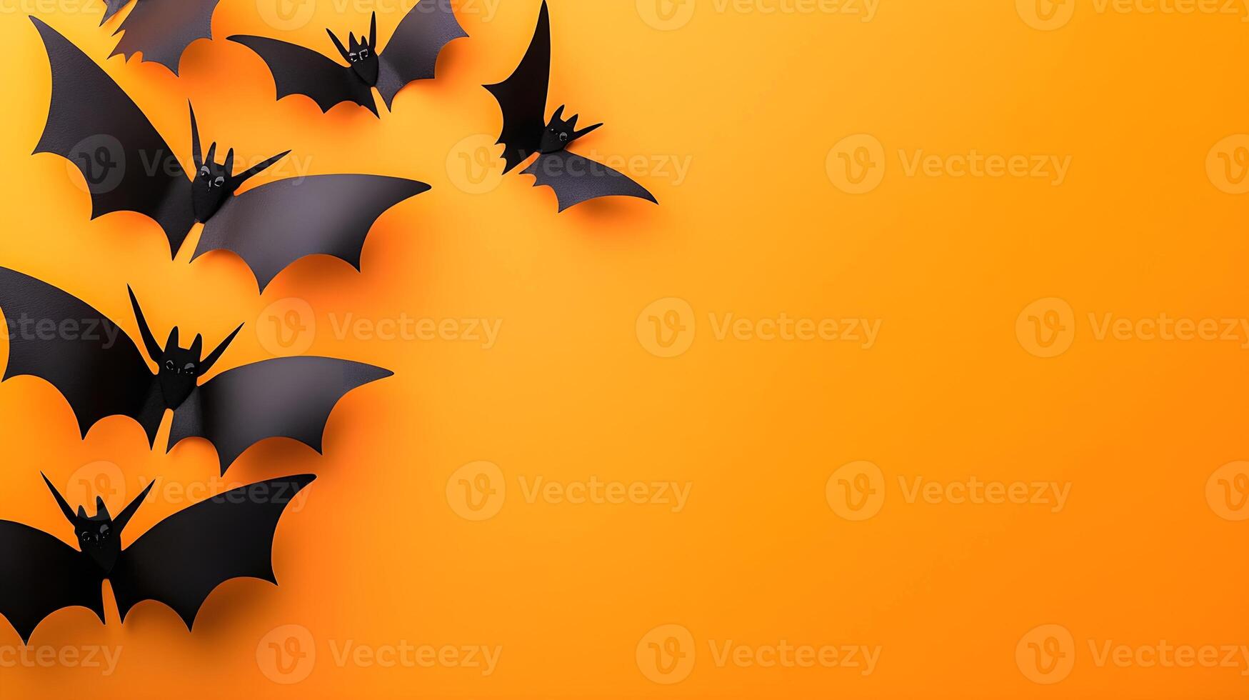 Black Bats Flying on Orange Background for Halloween Decorations photo