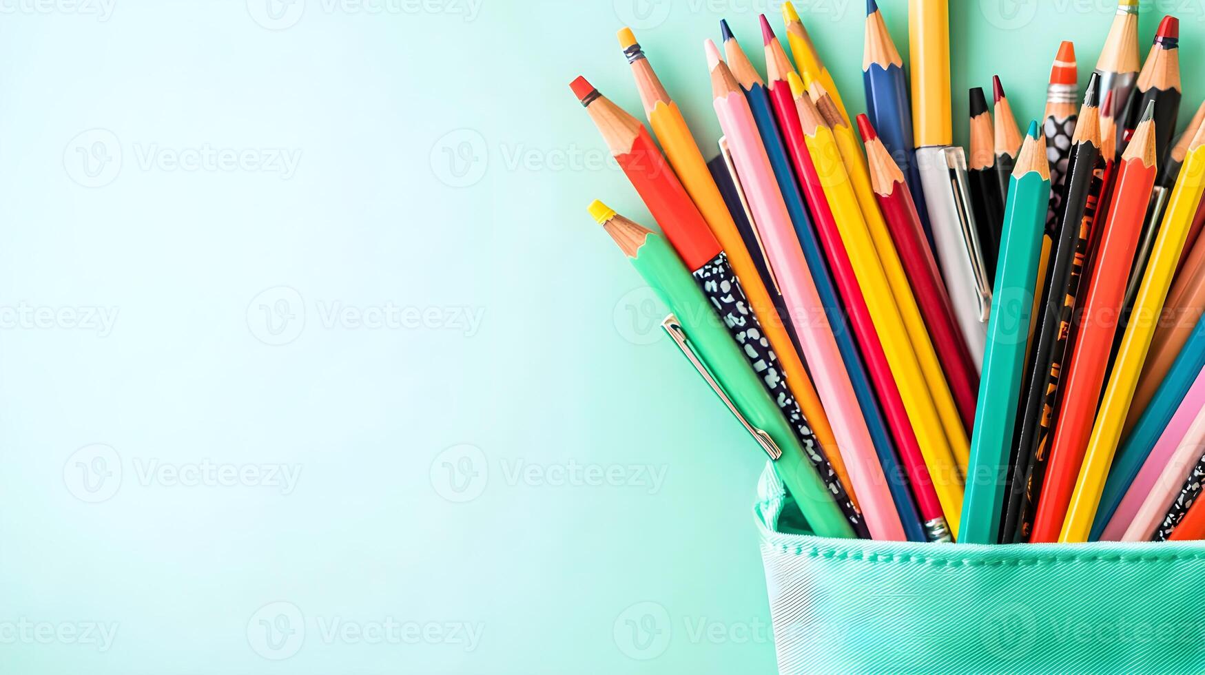 Colorful Variety of Pencils in Container on Light Mint Background photo