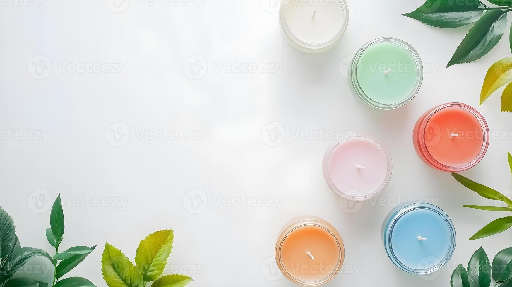 Colorful Candles Surrounded by Fresh Green Leaves on White Background photo