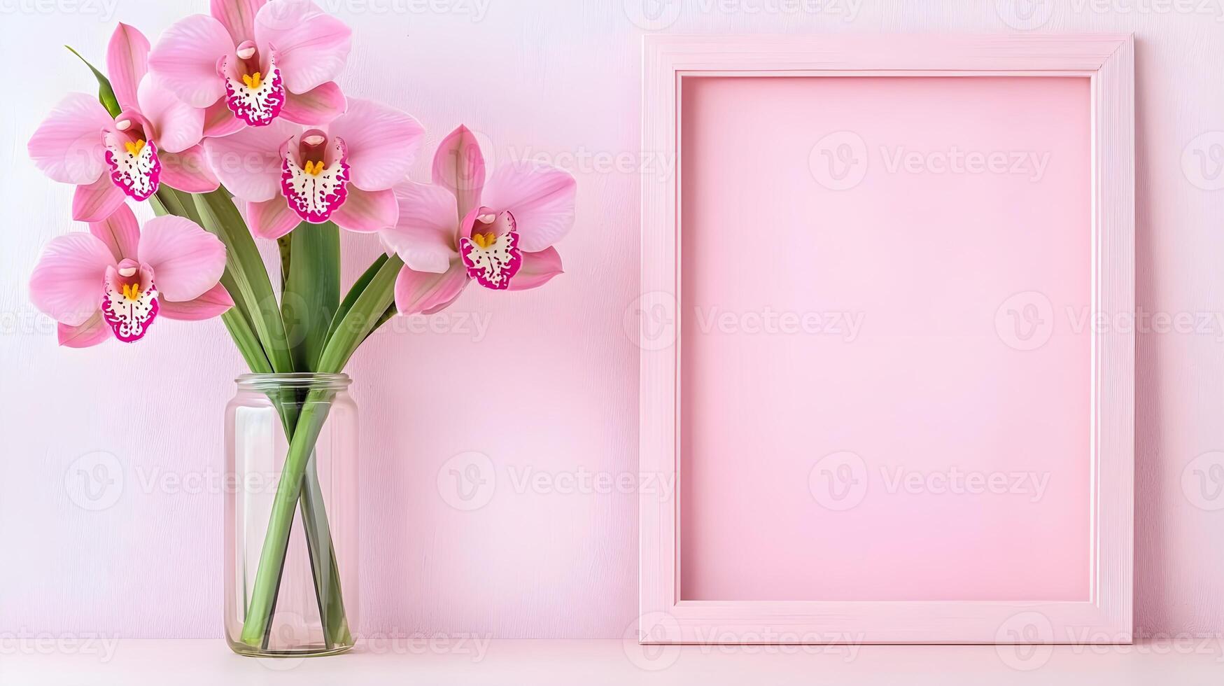 Pink Orchid Bouquet in Jar Next to Empty Pink Frame on Wall photo