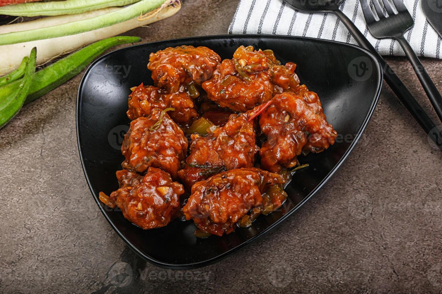 Manchurian chicken with sauce and spices photo
