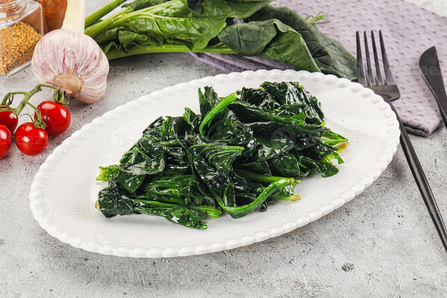 Coocked green spinach with oil photo