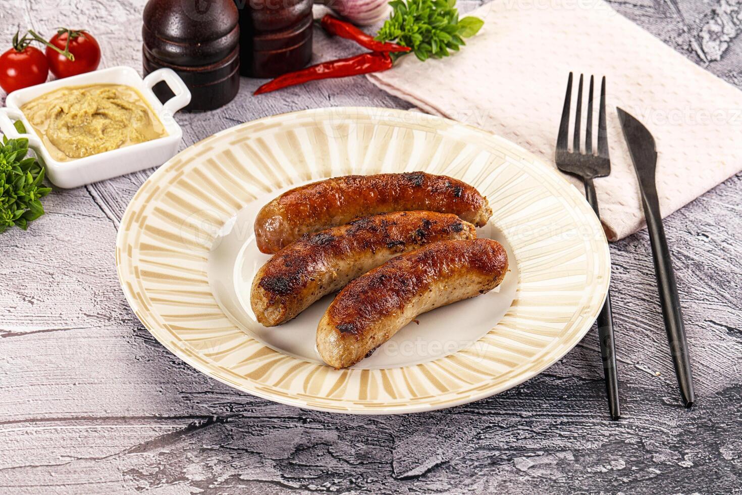 Delicous natural roasted sausages in the plate photo