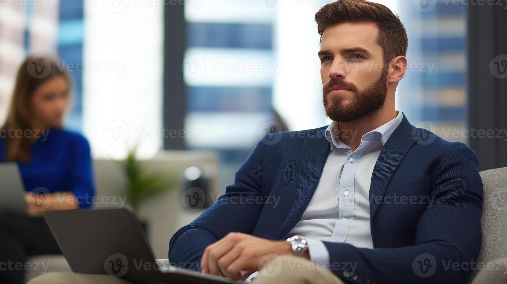 Thoughtful businessman in modern office setting with laptop photo