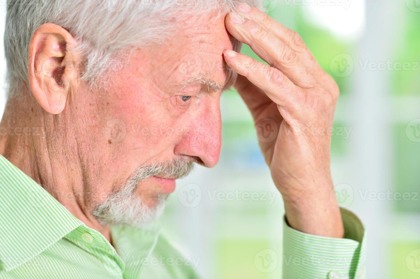 close-up portrait of a senior man thinking about something photo