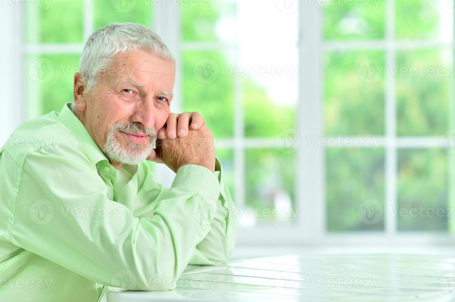 close-up portrait of a senior man thinking about something photo