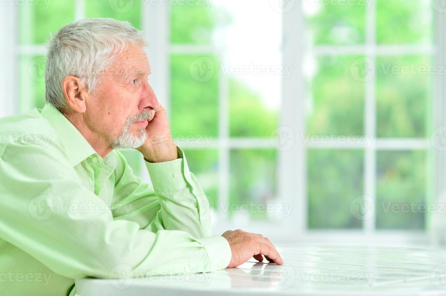 close-up portrait of a senior man thinking about something photo