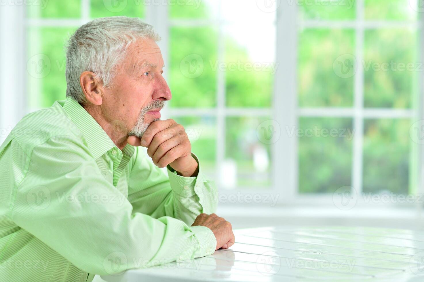 close-up portrait of a senior man thinking about something photo