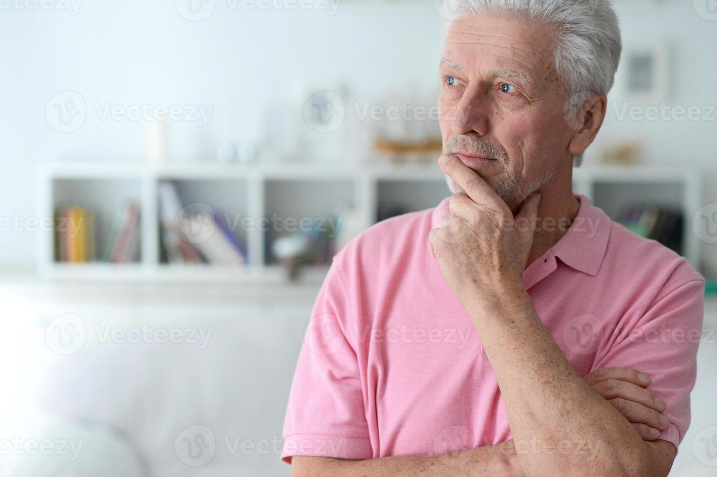 close-up portrait of a senior man thinking about something photo