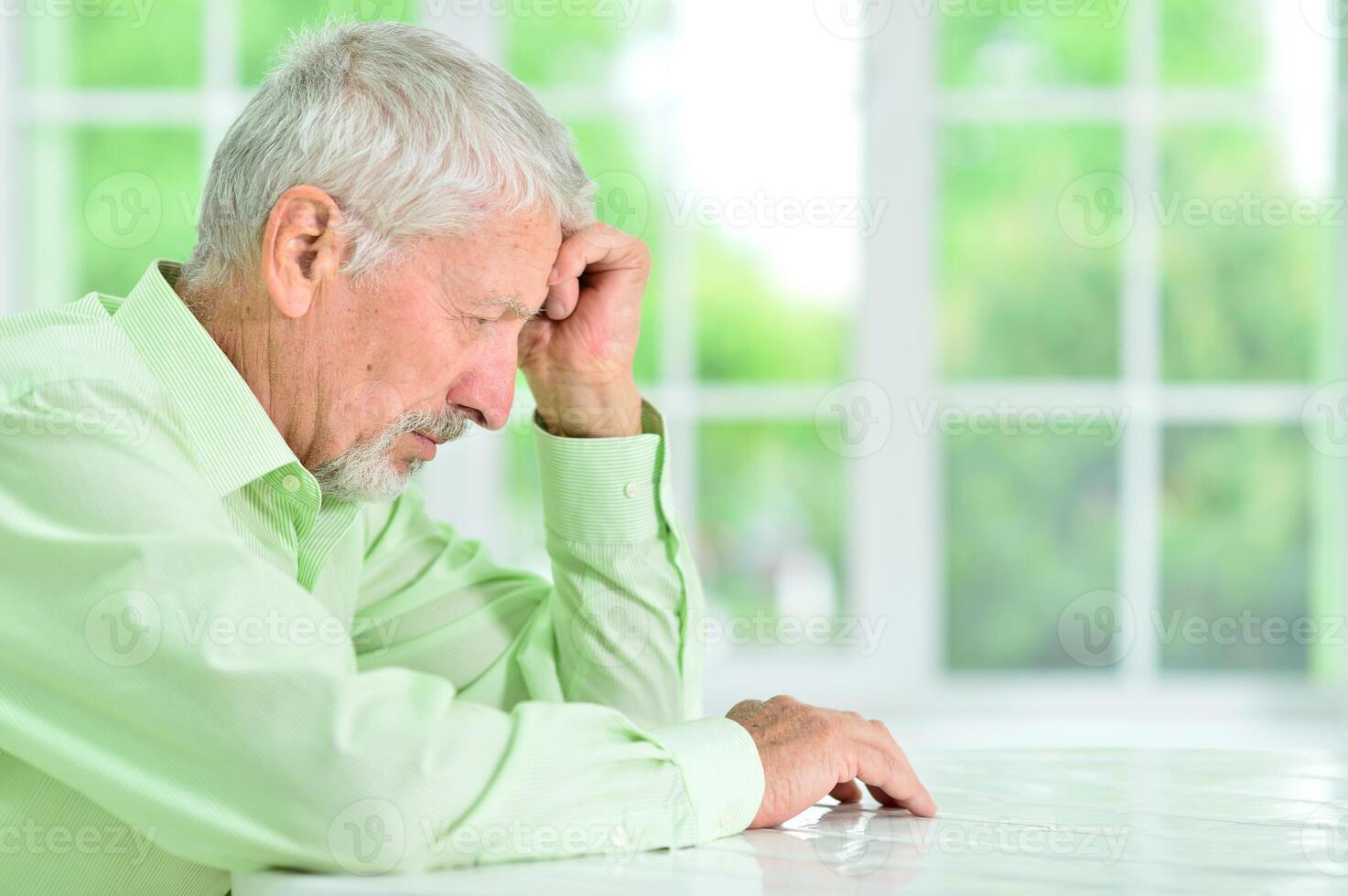 close-up portrait of a senior man thinking about something photo