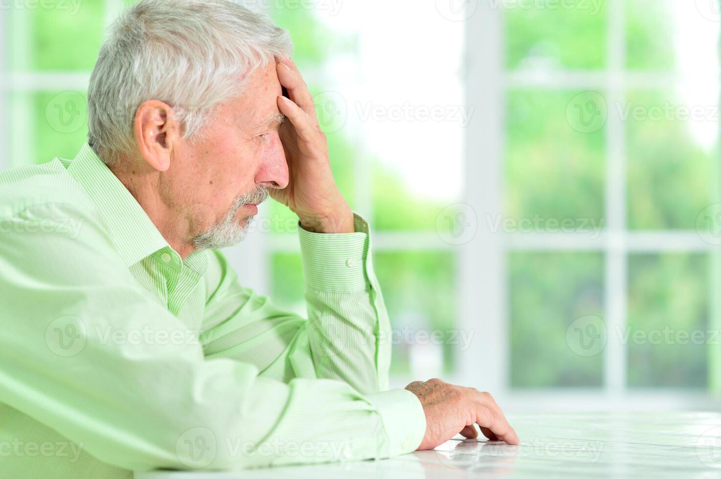 close-up portrait of a senior man thinking about something photo