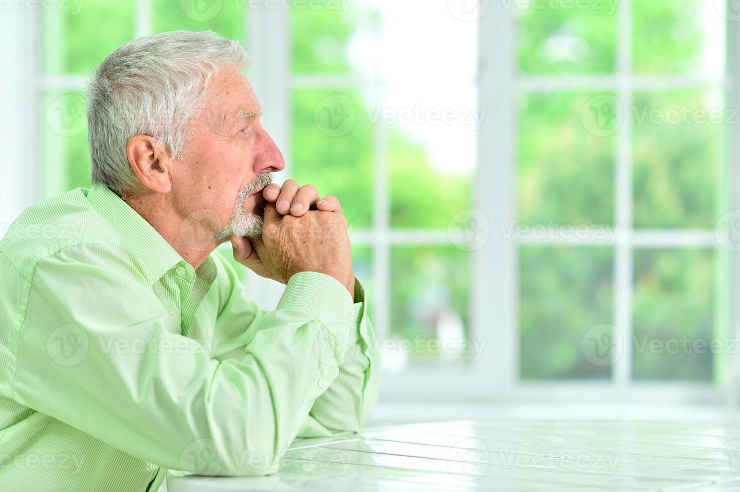 close-up portrait of a senior man thinking about something photo