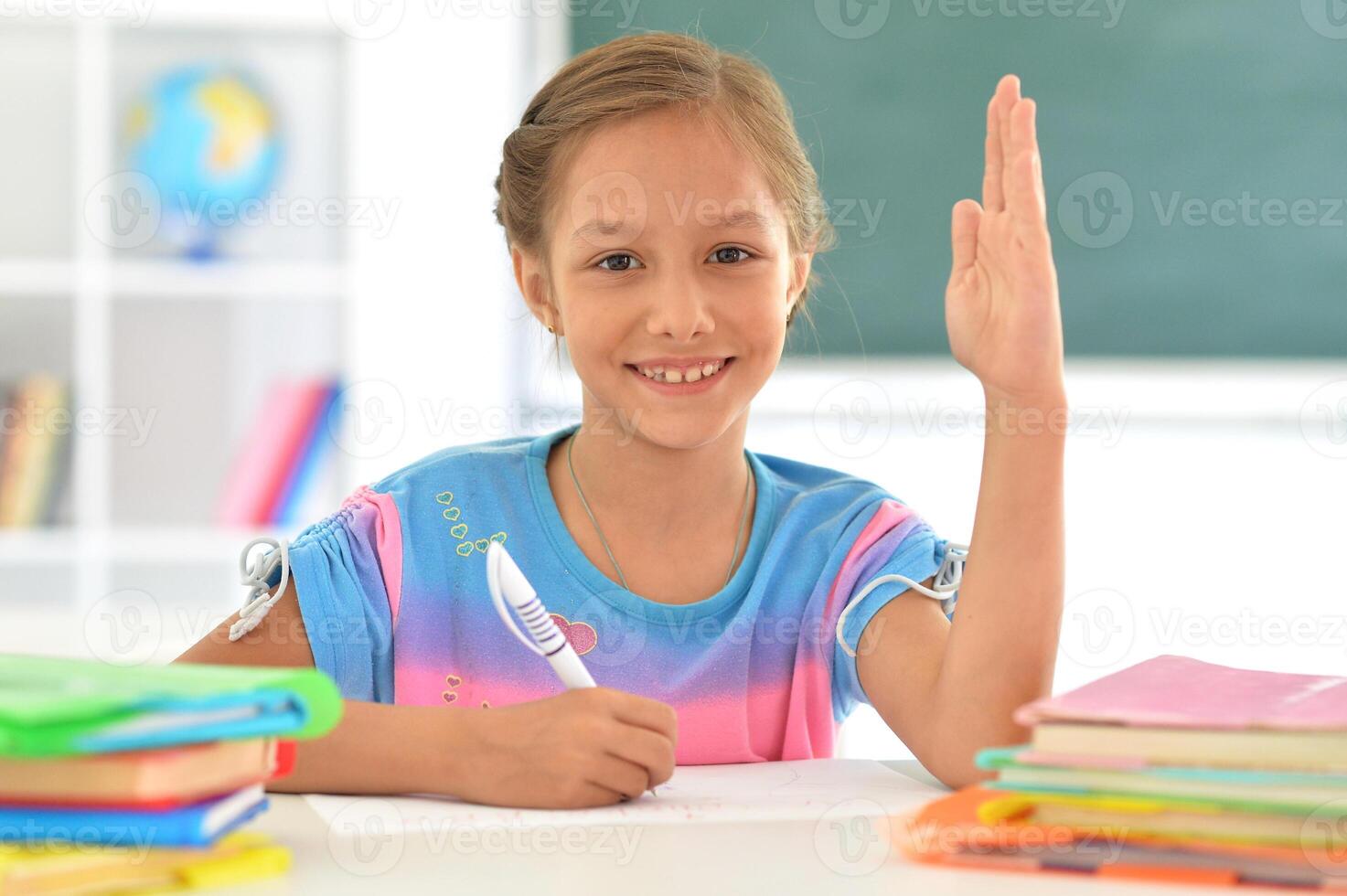 Portrait of girl studing with books at classroom photo