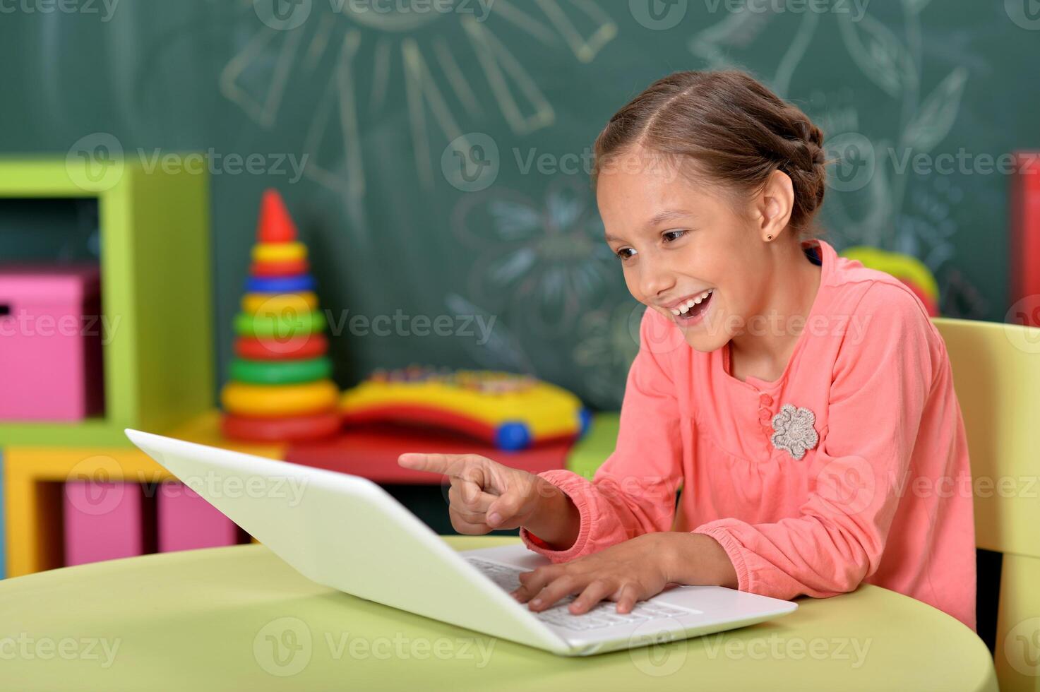Portrait of girl studing with laptop at classroom photo