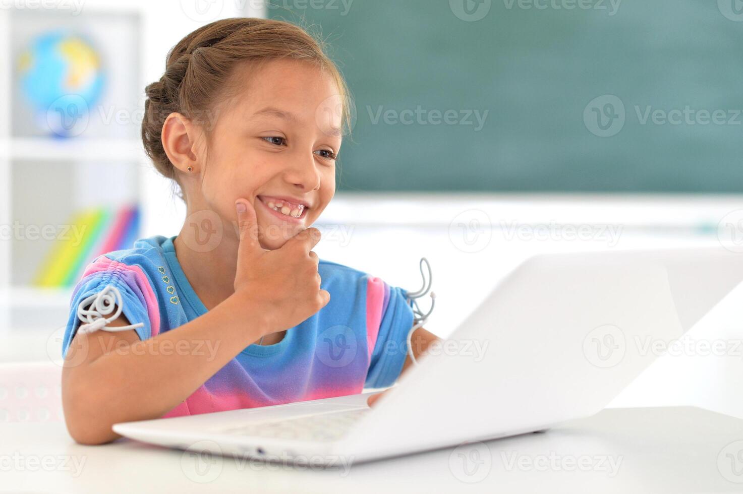 Portrait of girl studing with laptop at classroom photo