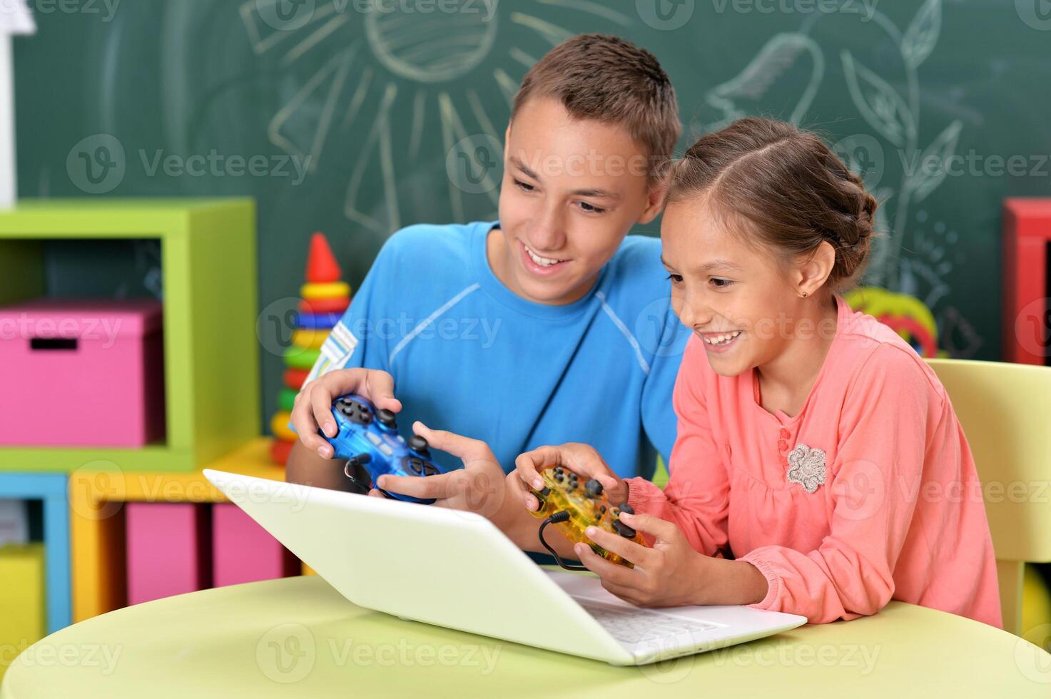 Portrait of brother and sister using laptop photo
