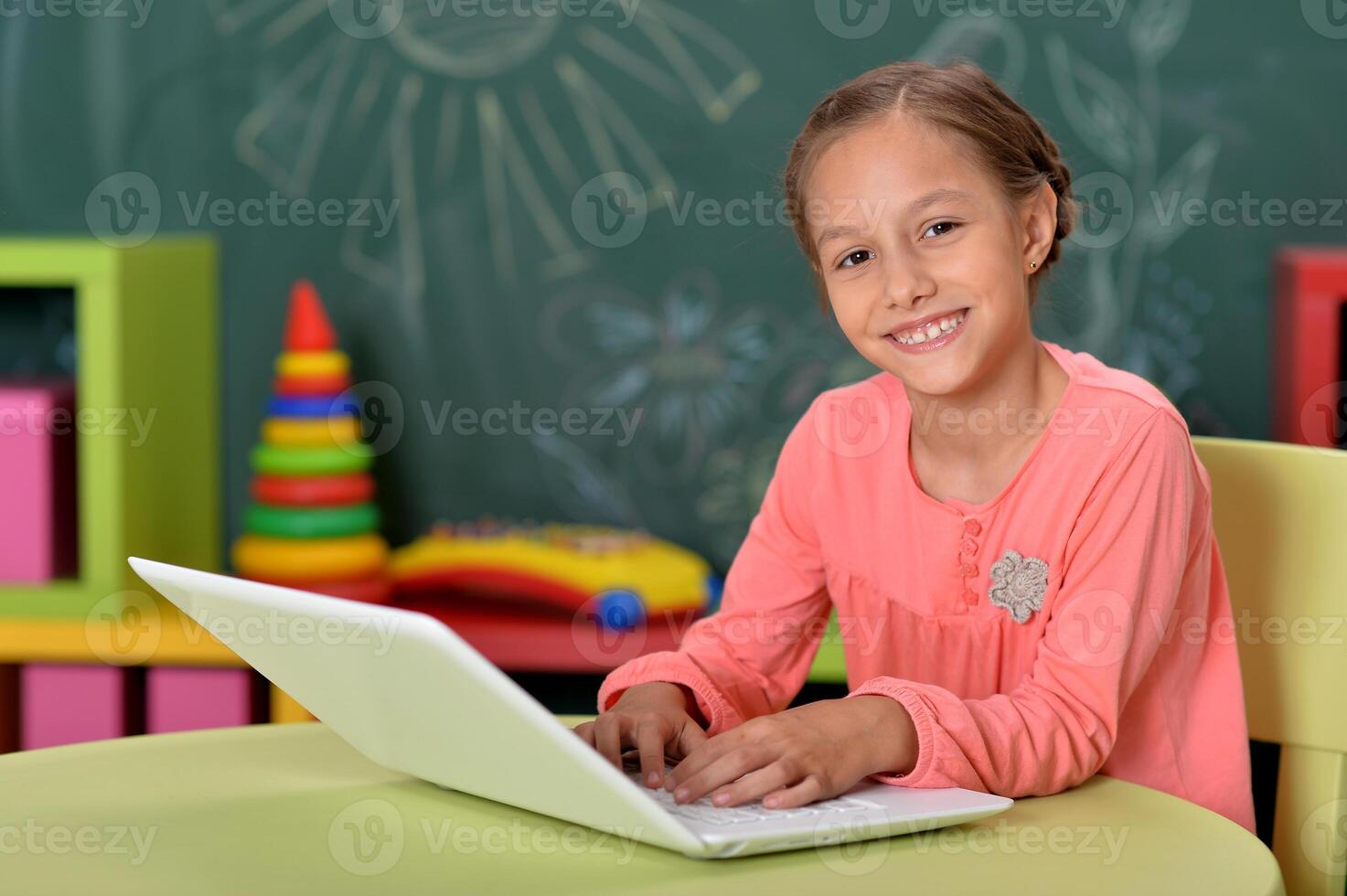 Portrait of girl studing with laptop at classroom photo